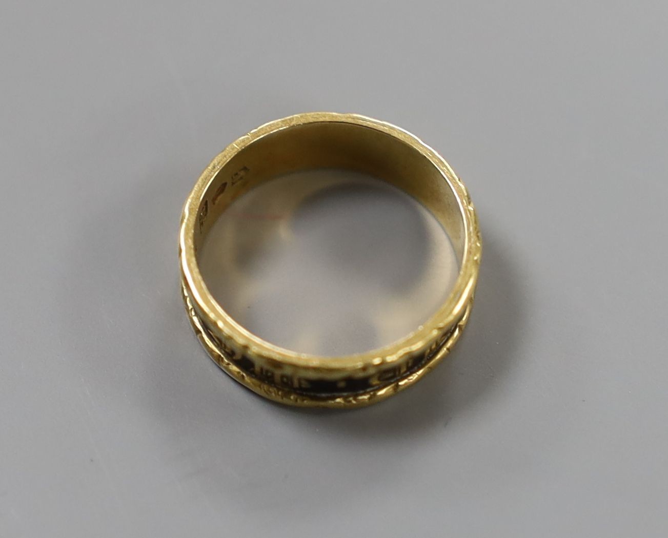 A late George IV 18ct gold and black enamel set mourning band, inscribed 'In Memory Of', shank hallmarked for Birmingham, 1829, size K/L, gross weight 3.2 grams.